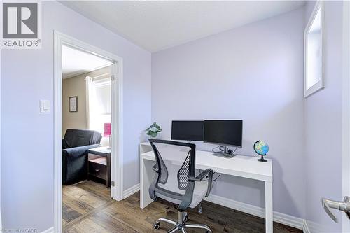 Interior room with wood-finish flooring, light-toned walls, and a white baseboard trim - 1406 Marshall Crescent, Milton, ON 