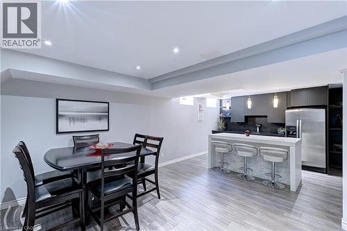 Open-concept living space with recessed lighting and wood-finish flooring - 1406 Marshall Crescent, Milton, ON 