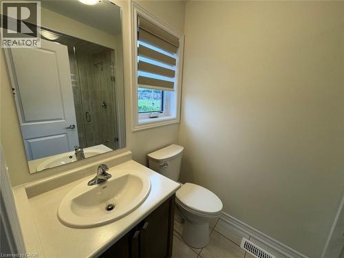Bathroom vanity with an integrated sink, polished chrome faucet, and a large mirror - 10 Guernsey Drive Unit# Upper, Kitchener, ON 