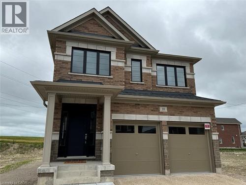 Two-story brick facade residence with stone accents and a covered front porch featuring columns - 10 Guernsey Drive Unit# Upper, Kitchener, ON 