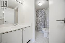 Bathroom vanity featuring a white countertop with integrated sink and chrome faucet - 
