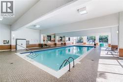 Indoor swimming pool featuring a tiled deck surround - 