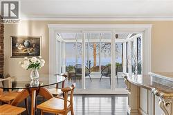 Sunroom extension with floor-to-ceiling windows, offering broad water scenery - 