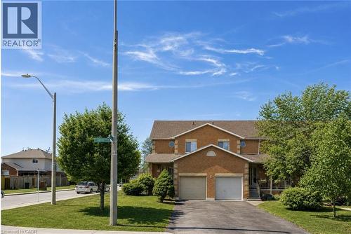Brick veneer exterior with a two-car garage, asphalt driveway, and a front porch - 125 Terni Boulevard, Hamilton, ON 