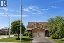 Brick veneer exterior with a two-car garage, asphalt driveway, and a front porch - 125 Terni Boulevard, Hamilton, ON 
