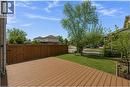 Expansive composite deck featuring a privacy fence with gate, manicured lawn, and mature trees - 125 Terni Boulevard, Hamilton, ON 