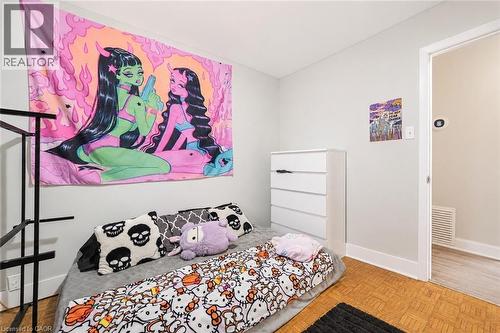 Room featuring parquet flooring and light-toned wall paint. Digitally enhanced. - 35 Vicmount Drive, Kitchener, ON 