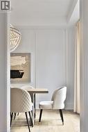 Dining area featuring light wood-finish flooring and wainscoting - 