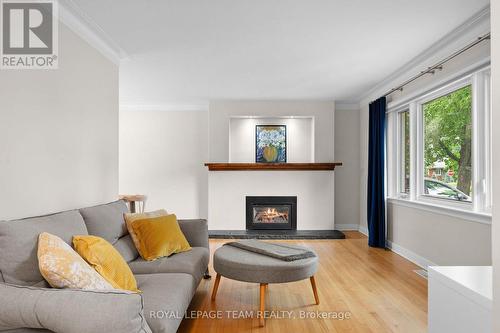 Flame in fireplace is virtually staged. - 631 Courtenay Avenue, Ottawa, ON 