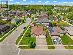 Aerial perspective showcasing a single-story residence with a brick facade and an attached garage - 