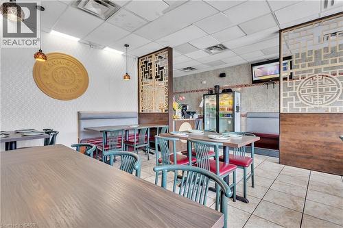Commercial interior featuring tiled flooring and drop ceiling with recessed lighting - 155 Highland Road E, Kitchener, ON 