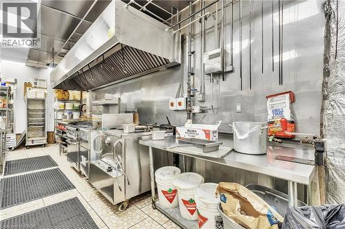 Commercial kitchen featuring stainless steel appliances and surfaces - 155 Highland Road E, Kitchener, ON 