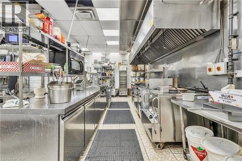 Commercial kitchen featuring stainless steel countertops and equipment - 155 Highland Road E, Kitchener, ON 