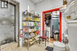 Commercial-grade space featuring white subway tile walls and textured floor tiles - 