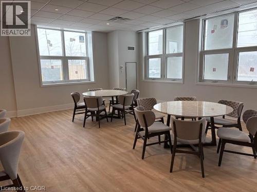 Spacious room featuring multiple large windows, wood-finish flooring, recessed lighting, and a neutral color palette - 1936 Rymal Road E Unit# 516, Hannon, ON - Indoor Photo Showing Dining Room