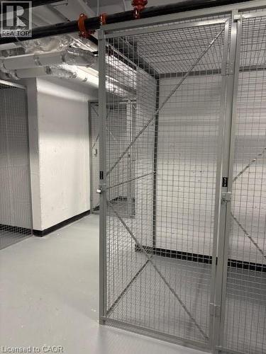 Individual storage unit featuring a galvanized wire mesh door with latch - 1936 Rymal Road E Unit# 516, Hannon, ON - Indoor Photo Showing Garage