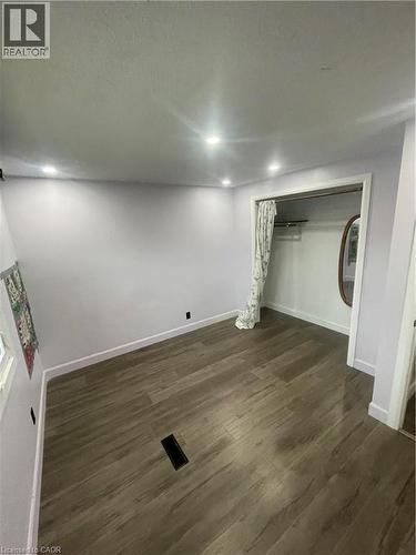 Interior room featuring wood-finish flooring, recessed ceiling lighting, and a closet with a curtained entry - 134 Bridgeport Road E Unit# Upper, Waterloo, ON 