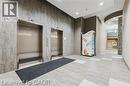 Twin stainless steel elevators set within a textured wall - 280 Lester Street Unit# 607, Waterloo, ON 