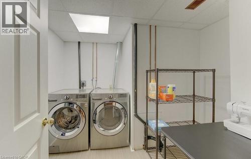Dedicated utility area featuring a paneled interior door, light-toned wood-finish flooring, and a drop ceiling with recessed lighting - 458 Beechwood Place Unit# 3, Waterloo, ON - Indoor Photo Showing Laundry Room