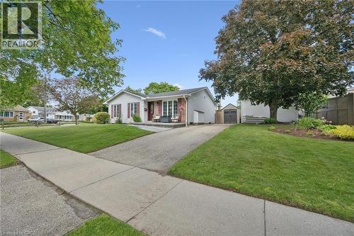 Ranch-style exterior with white siding and brick accents - 2 Keewatin Avenue, Kitchener, ON 