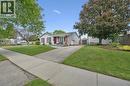 Ranch-style exterior with white siding and brick accents - 2 Keewatin Avenue, Kitchener, ON 
