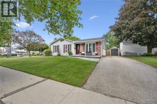 White siding exterior with brick accents and red shutters - 2 Keewatin Avenue, Kitchener, ON 