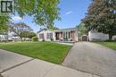 White siding exterior with brick accents and red shutters - 2 Keewatin Avenue, Kitchener, ON 