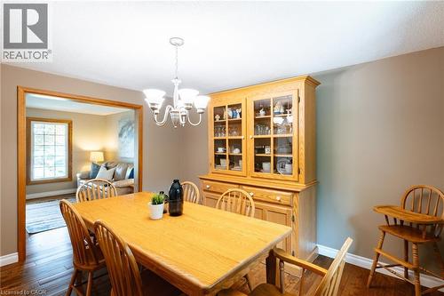 Dedicated dining area featuring wood-finish flooring and a multi-light chandelier - 28 Mcgibbon Court, Kitchener, ON 