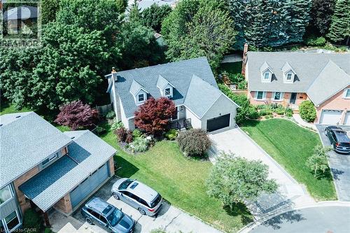 Two-story residence with a gray shingle roof and three dormer windows - 28 Mcgibbon Court, Kitchener, ON 