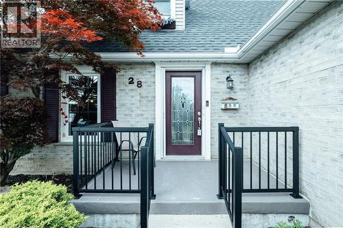 Brick facade featuring a partial porch with black metal railings - 28 Mcgibbon Court, Kitchener, ON 