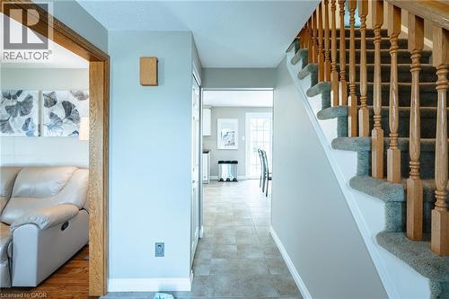 Carpeted staircase with natural wood balusters and handrail - 28 Mcgibbon Court, Kitchener, ON 