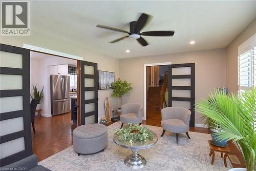 Living space featuring a neutral color palette, wood-finish flooring, recessed lighting, and a ceiling fan - 8 Sheridan Boulevard, Simcoe, ON 