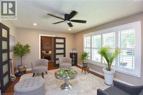 Living area featuring plantation shutters, recessed lighting, and a ceiling fan - 8 Sheridan Boulevard, Simcoe, ON 