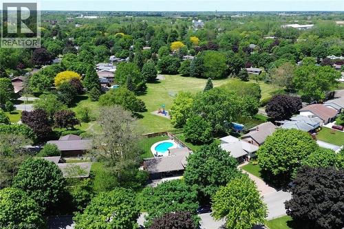 Aerial perspective showcasing a residential area with extensive tree coverage and varied rooflines - 8 Sheridan Boulevard, Simcoe, ON 