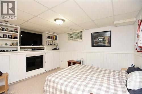Built-in entertainment center featuring shelving, cabinetry, and a central fireplace - 8 Sheridan Boulevard, Simcoe, ON 