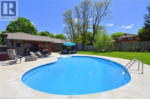 Curved inground pool with concrete surround - 8 Sheridan Boulevard, Simcoe, ON 