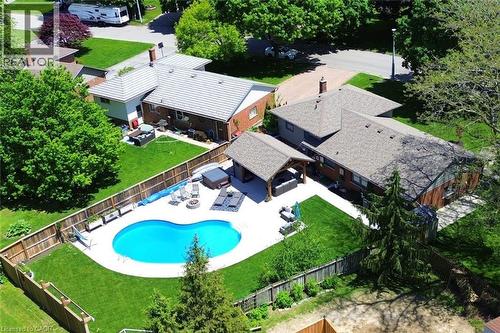 Curved inground pool with surrounding concrete patio - 8 Sheridan Boulevard, Simcoe, ON 