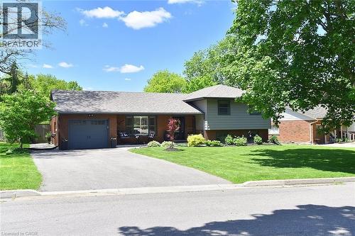 Brick and siding exterior with a dark gray garage door - 8 Sheridan Boulevard, Simcoe, ON 
