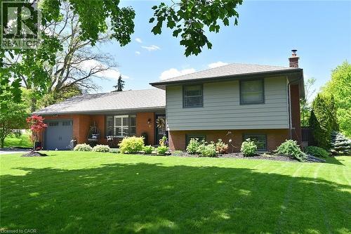 Split-level residence featuring a brick and siding exterior with an attached garage - 8 Sheridan Boulevard, Simcoe, ON 