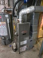 Utility room with heating unit and gas water heater - 