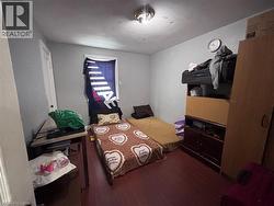 Bedroom featuring dark wood-type flooring - 