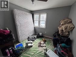 Bedroom featuring a ceiling fan and baseboards - 