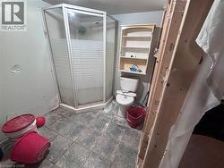 Bathroom featuring toilet and a stall shower - 
