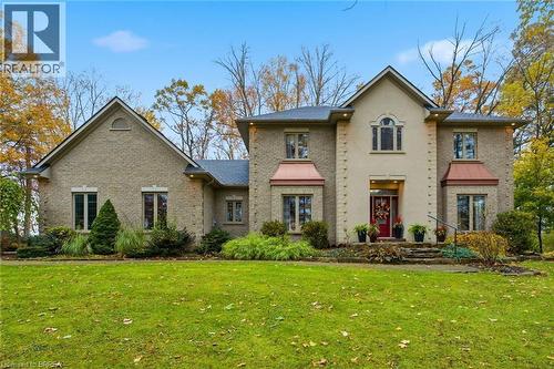 Stone facade residence featuring a prominent red entry door - 271 Windham Rd 14, Simcoe, ON 
