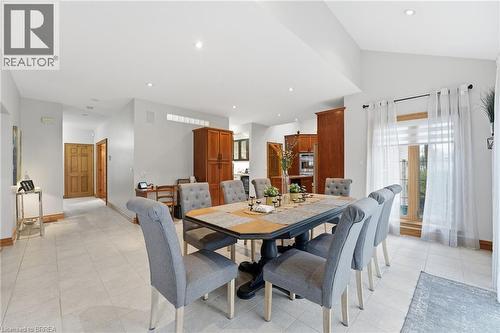 Open-concept dining area featuring light tile flooring, recessed lighting, and vaulted ceilings - 271 Windham Rd 14, Simcoe, ON 