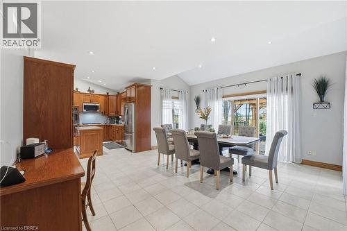 Expansive open-concept space featuring light-toned tile flooring, recessed lighting, and a vaulted ceiling - 271 Windham Rd 14, Simcoe, ON 
