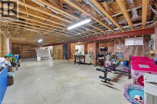 Unfinished basement offering expansive concrete flooring, exposed wood joists, and structural steel beams - 271 Windham Rd 14, Simcoe, ON 