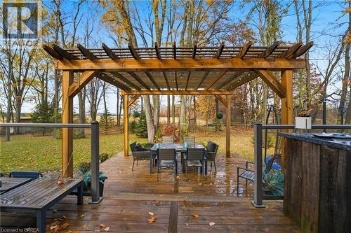 Expansive wood-finish deck with a large pergola featuring integrated string lighting - 271 Windham Rd 14, Simcoe, ON 