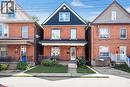 Brick exterior featuring a gabled roofline with dark siding - 38 Fairleigh Avenue N, Hamilton, ON 