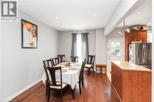 Open-concept dining area featuring recessed lighting, wood-finish flooring, and a window with dark drapery - 38 Fairleigh Avenue N, Hamilton, ON 